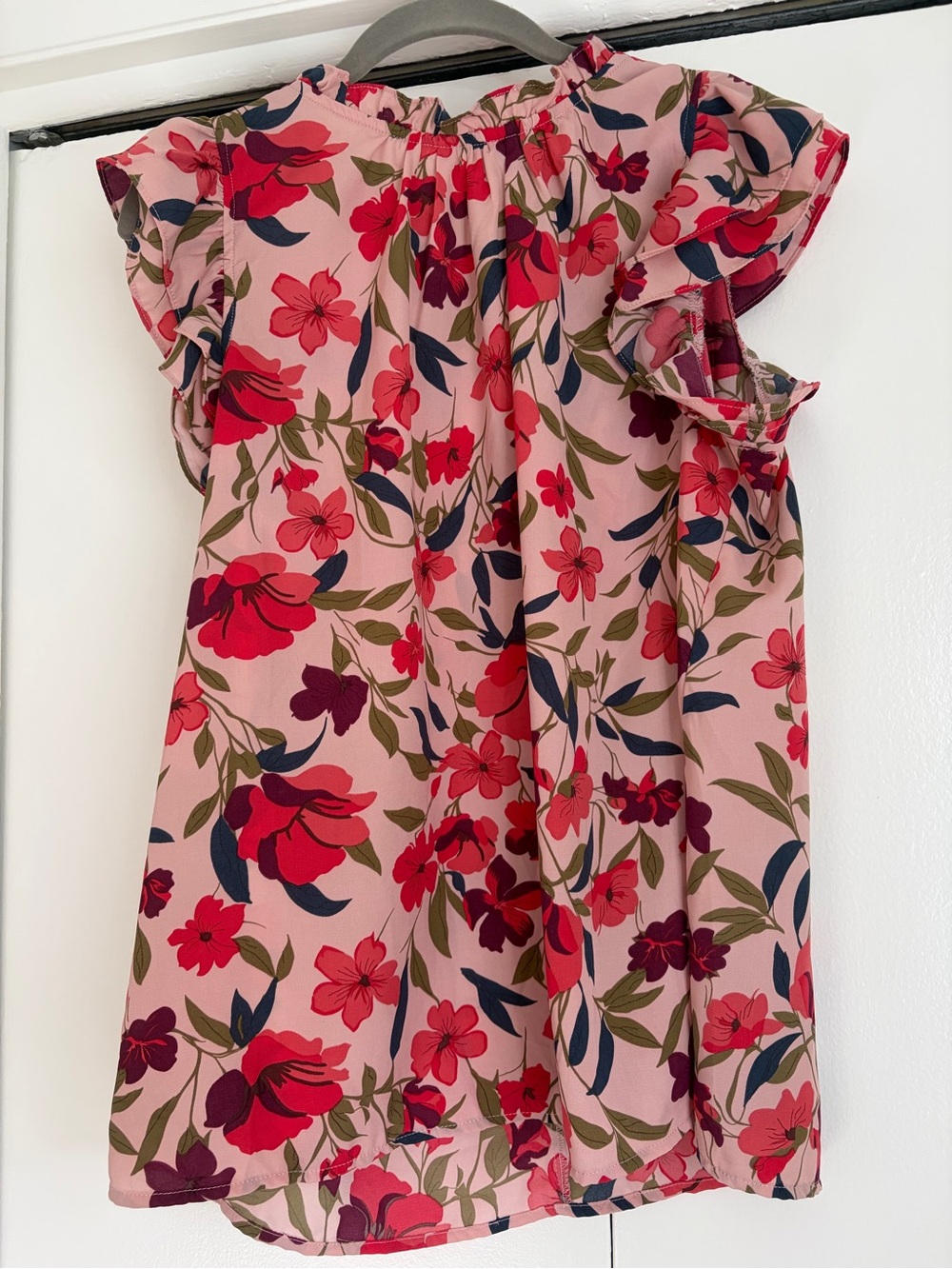 Pink and red sleeveless floral blouse